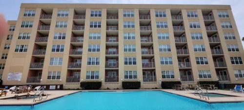 a large apartment building with a swimming pool at Gulfview II #604 in South Padre Island