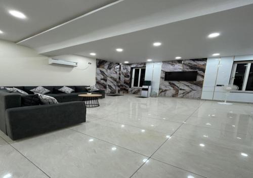 a large living room with a couch and a table at Aditi Hotel and Banquets in Karīmnagar