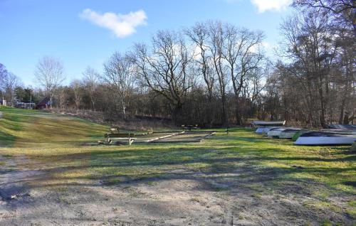 a park with benches and boats in the grass at 1 Bedroom Cozy Home In Blentarp in Blentarp