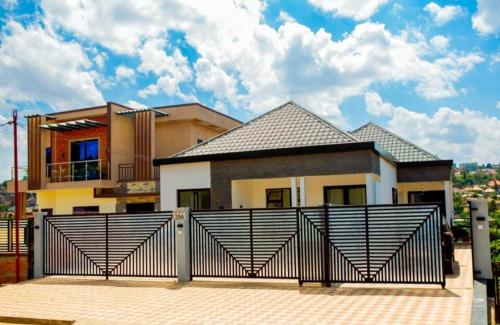 a house with a gate in front of it at Serene Rwanda Adventure in Kigali