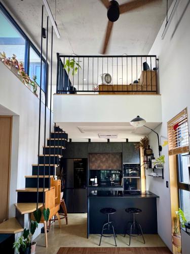 an open kitchen and living room with a staircase at Rooftop House Seongsu in Seoul