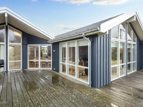 an exterior view of a house with a deck at 10 person holiday home in Harboøre-By Traum in Harboør