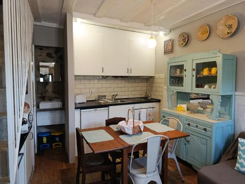 a kitchen with a table and a small kitchen with a counter at Casa da Ponte in São Pedro do Sul
