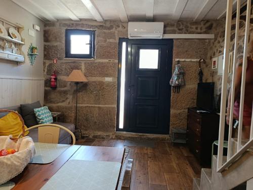 a living room with a black door and a couch at Casa da Ponte in São Pedro do Sul