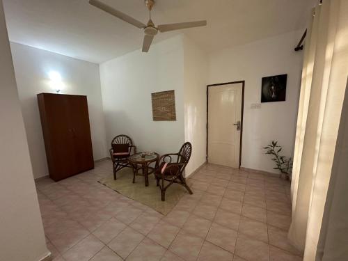 a dining room with a table and chairs in a room at Orchid Villa Negombo in Negombo