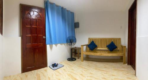 a room with a room with a door and a chair at A&C Aquino Guesthouse in Moalboal