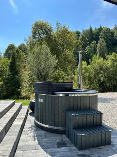 a circular seating area with trees in the background at Podhorský Apartmány Terchová in Terchová