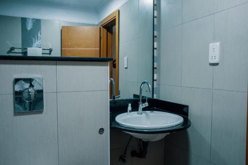 a bathroom with a sink and a mirror at Morning Side Suites in Lagos