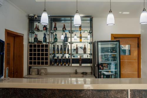 a bar with a display of wine bottles at Morning Side Suites in Lagos