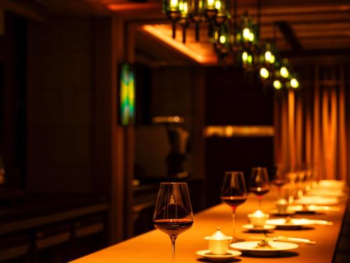 a row of wine glasses sitting on a table at UMITO Atami Bettei in Atami