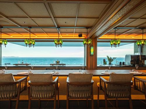 a dining room with a view of the ocean at UMITO Atami Bettei in Atami