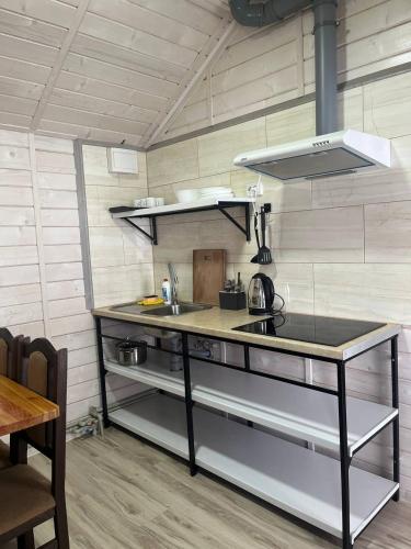 a kitchen with a counter top in a room at Hotels mim in Vorokhta