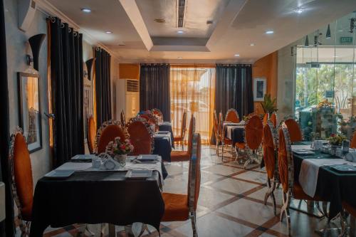 a restaurant with tables and chairs in a room at Morning Side Suites in Lagos