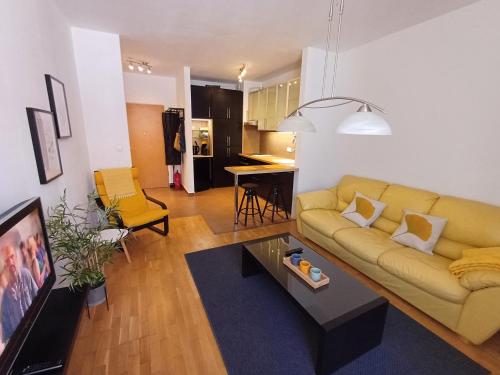 a living room with a couch and a table at Belvárosi apartman in Gyöngyös