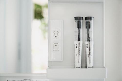 a white cabinet with three tooth brushes in it at 1NLDK hyuga in Hyuga