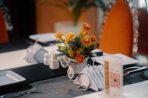 a table with a vase of flowers on a table at Morning Side Suites in Lagos