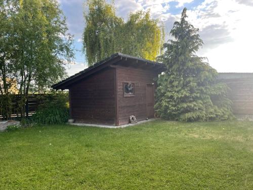 a small building in the grass in a yard at Family house in Pardubice