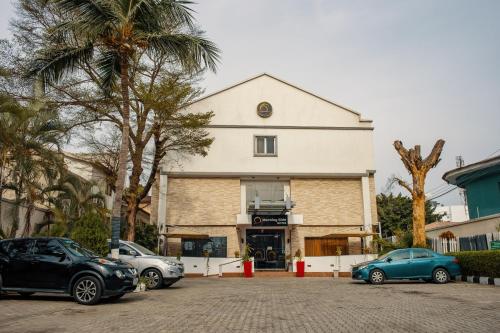 a building with cars parked in front of it at Morning Side Suites in Lagos
