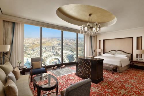 a hotel room with a bed and a large window at Makkah Clock Royal Tower, A Fairmont Hotel in Makkah