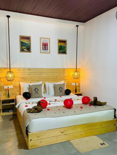 a bedroom with a large bed with red balloons on it at La Casa Bella in Ella