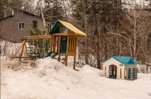 a playground in the snow with a small house at Spa - Waterfront - La Source in Saint Come