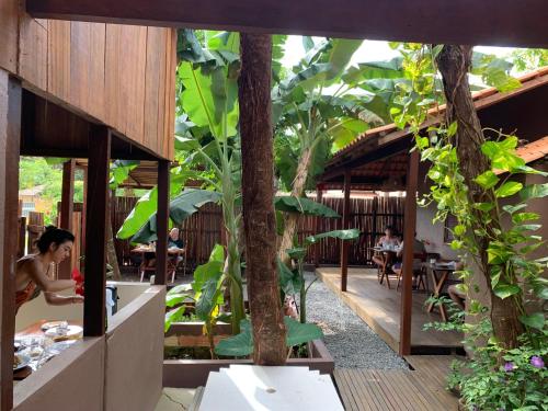 a restaurant with trees and people sitting at tables at Canto Carauari Pousada in Alter do Chao