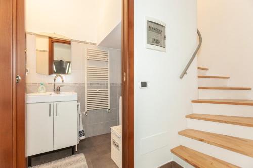 a bathroom with a sink and a staircase at Bright Villa with Balcony and Jacuzzi, Milan Area in Cesate