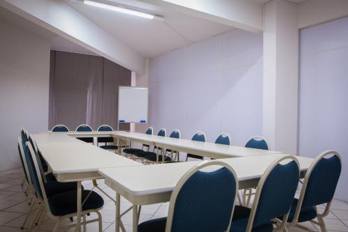 a conference room with a long table and chairs at Real NOB Hotel in Orleans