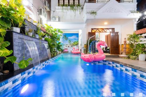 a pool with pink inflatable flamingos in a house at Villages Hồ Bơi Võ Thị Sáu Lô Góc gần Quảng Trường in Vung Tau