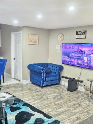 a blue couch sitting in a living room at Beautiful 3 bedrooms, 2 bathrooms, 4 beds sleep 8, basement close to Falls in Niagara Falls