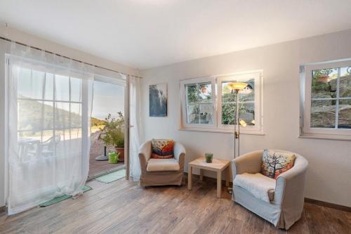 a living room with two chairs and a window at Ferienwohnung Weitblick in Sasbachwalden