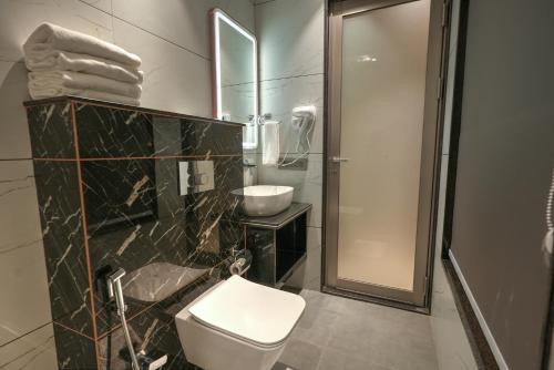 a bathroom with a toilet and a sink and a shower at RC Dream Palace in Greater Noida