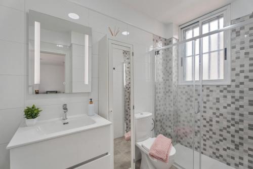 a white bathroom with a sink and a toilet at Costa Serena in Arona