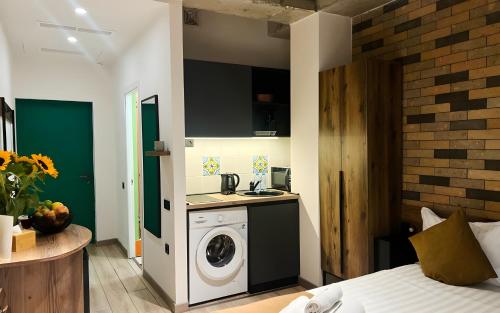 a kitchen with a washing machine in a bedroom at Rooms Apart Hotel by RED in Yerevan