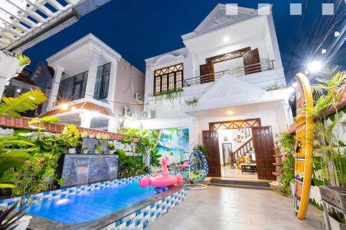 a house with a water park in front of it at Hoàng My Villa Hồ Bơi Bãi Sau căn Góc in Vung Tau