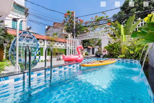 a pool with two inflatables and a water park at Hoàng My Villa Hồ Bơi Bãi Sau căn Góc in Vung Tau