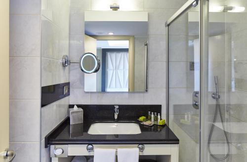 a bathroom with a sink and a shower at DoubleTree by Hilton Izmir - Alsancak in Izmir