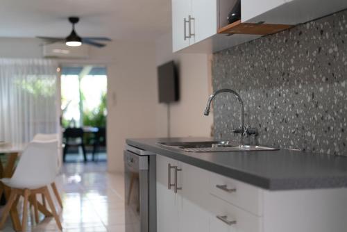 a kitchen with a sink and a counter top at Beachcomber Peregian Beach in Peregian Beach