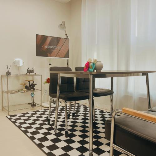 een eetkamer met een tafel en stoelen op een geruite vloer bij Urban Retreat 3-Min Walk from Achasan Station, 15-Min to Seongsu, Tranquil Space for Relaxation in Seoul