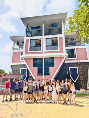 a group of people standing in front of a building at Orchid Pool Villa Phuket - SHA Extra Plus in Phuket Town