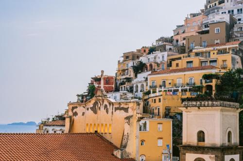 a group of buildings on a hill with the ocean at Dimora Donna Teresa in Positano