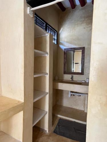 a bathroom with a sink and a mirror at La Joya Lamu in Shela