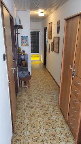 a hallway with a door and a room with a floor at Z21 Apartman in Balatonföldvár