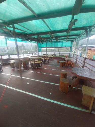 a group of tables and benches in a building at Varvara hill in Cigugur