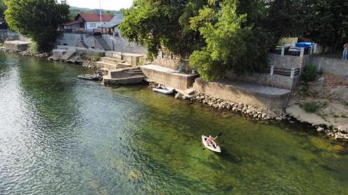 a person in a boat in a river at Apartman na Drini in Loznica