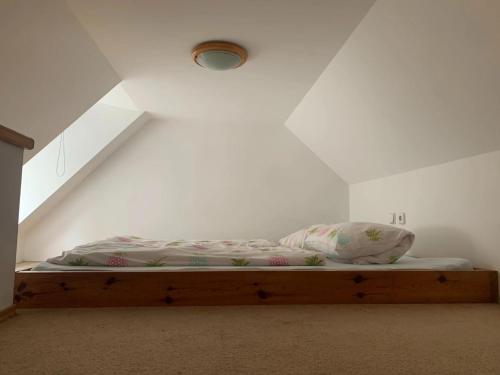 a bed in a room with a attic at Penzion a Restaurace Pintovka in Tábor