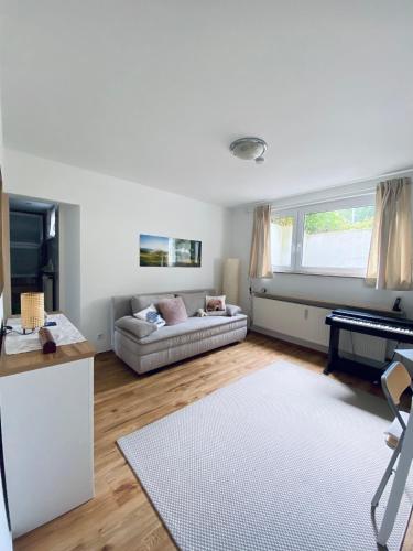a living room with a couch and a table at Helles, gepflegtes Souterrain Apartment in ruhiger Lage in Düsseldorf