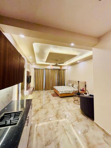 a living room with a bed in the background at CotySoulStay in Ghaziabad