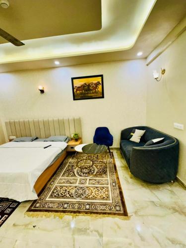 a bedroom with a bed and a chair and a rug at CotySoulStay in Ghaziabad