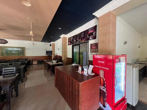 a fast food restaurant with a red coke machine at Collection O Bali near Bajra Sandhi Monument formerly Hotel Puri Samaritan in Denpasar